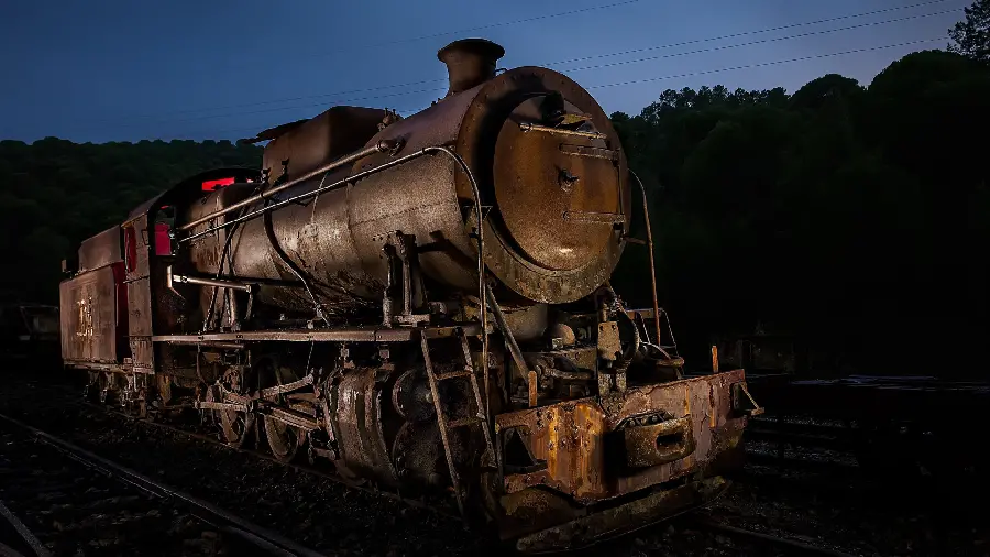 Profile Photo of an Old Locomotive and Freight Car on the Rails at Night in HD Quality
