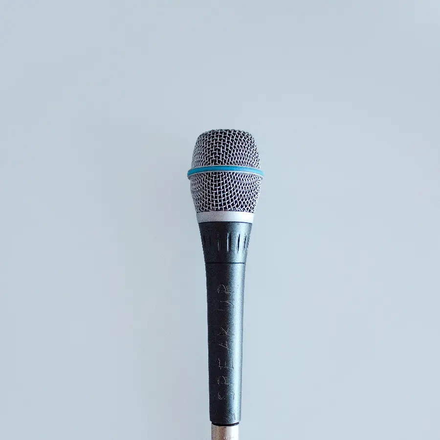 Stylish and special minimalist background microphone design with a simple blue background 
