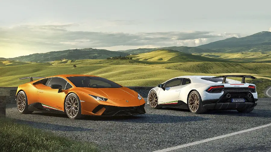 The latest models of the white and orange Lamborghini Huracán side by side