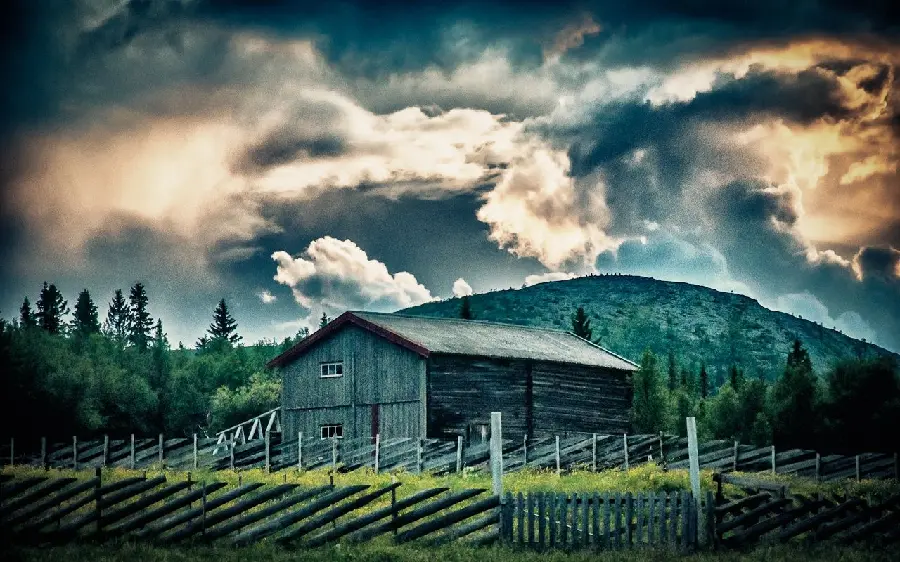 High quality wallpaper of a barn among wooden fences