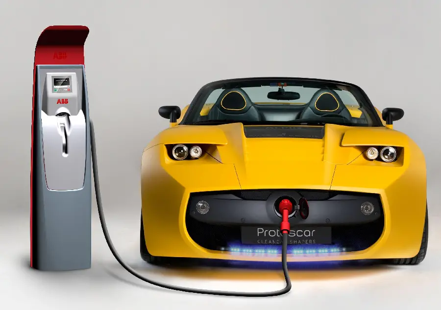 Photo of a yellow electric car charging with a plain background