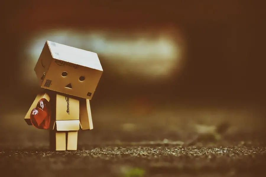 Stock photo of a sad and lonely wooden figure walking 