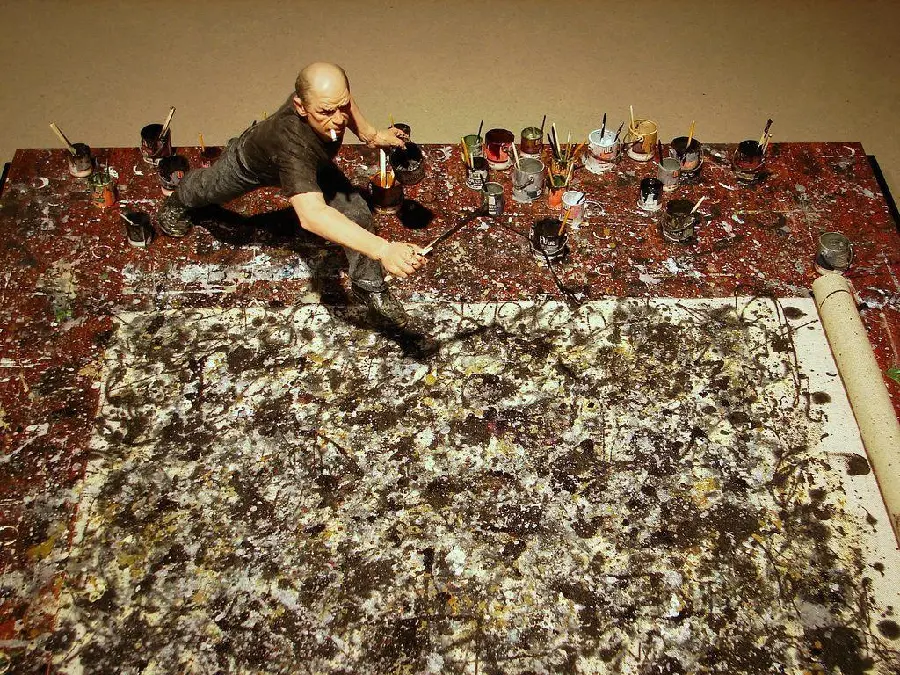 Splashing and dripping paint in the style of American modernist painter Jackson Pollock's action painting