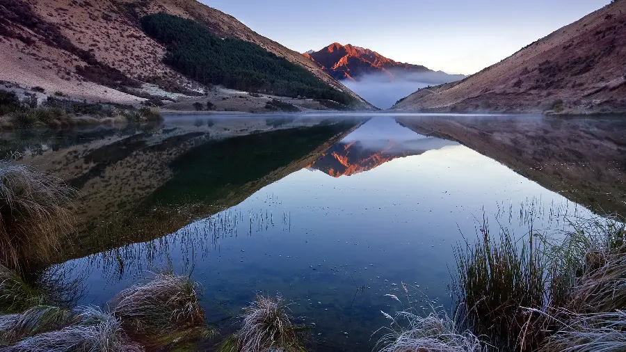 Download unique and special seascape wallpaper between two mountains 