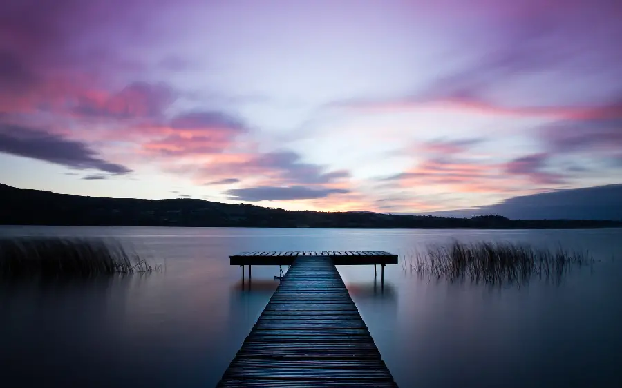 A very beautiful photo of a bridge and lake in pristine nature