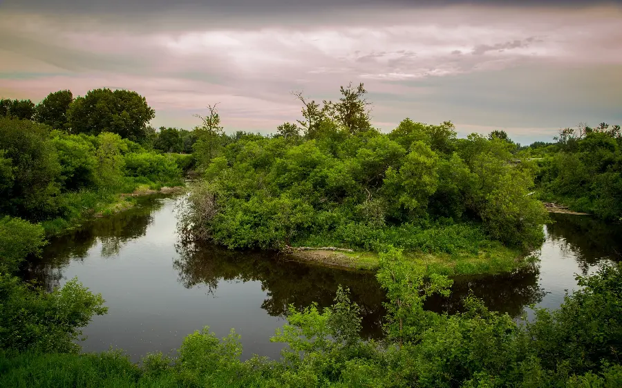 Strange image of natural landscape of valley and gap between the ground with trees filled with river water 