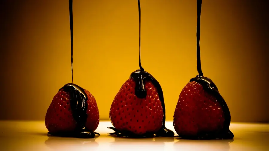 Background withMouthwatering chocolate launcher design on strawberries