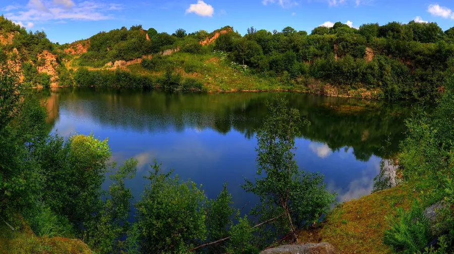Download the background of a relaxing nature design of a lake in the middle of the mountain 