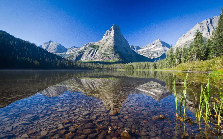 Background photo of the reflection of the mountain image in the transparent lake of nature