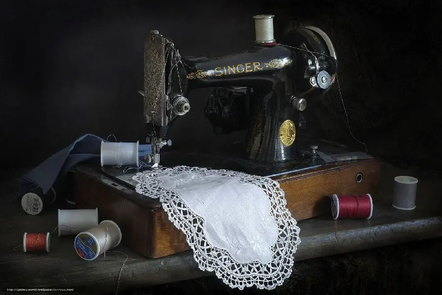 Image of a sewing machine sewing old and classic style tablecloths 