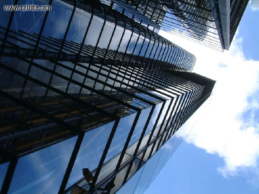 Photo of a huge skyscraper with a glass facade with a solid body and strong connections