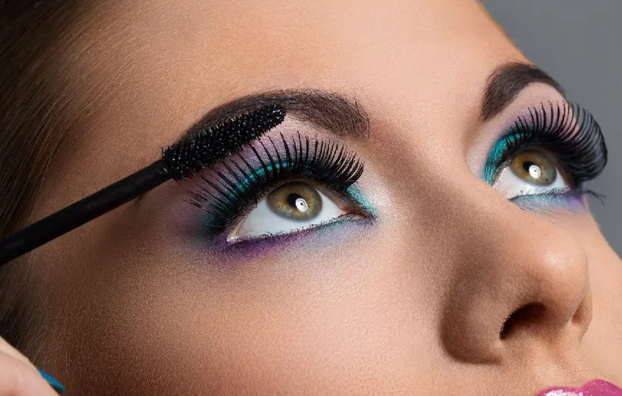 Download photo of a female eyelash model applying mascara with long and thick black eyelashes 