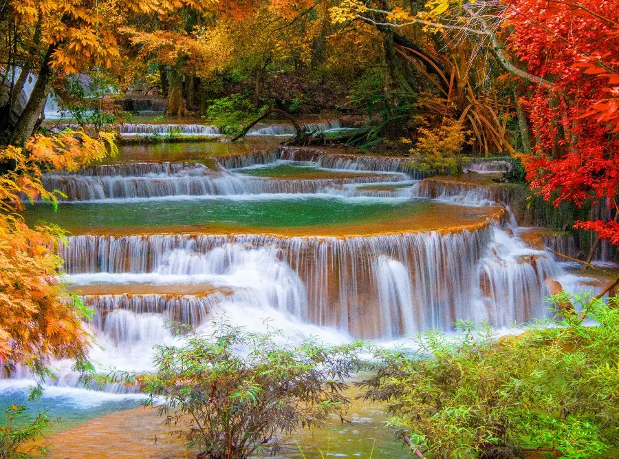 The unique and incredible nature of the waterfall in the autumn forest 
