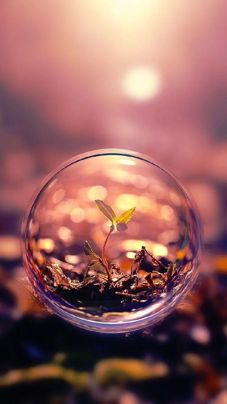 Download photo of a crystal ball resembling a drop of water with a sunset background