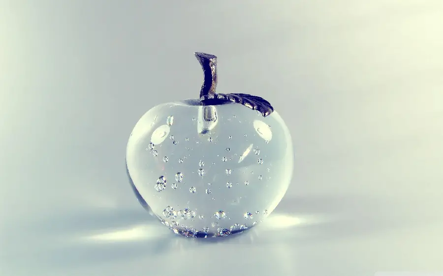 Download photo of a crystal apple and transparent glass with a white background for your profile and computer background