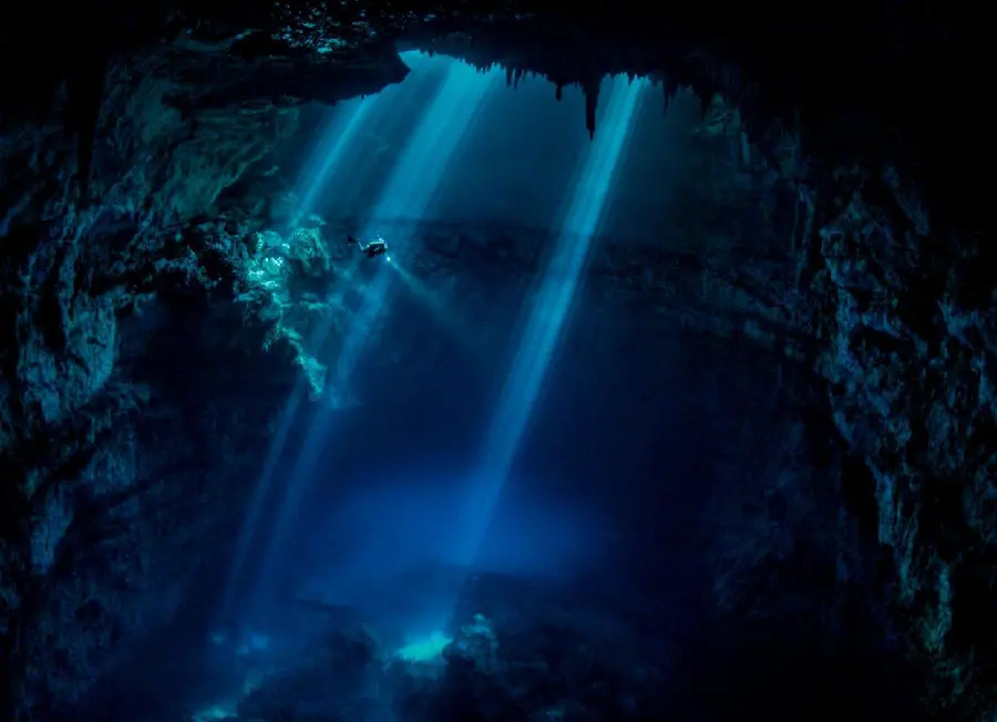 Dark and strange cave mouth wallpaper with flickering blue lights