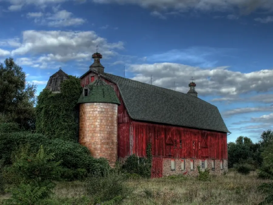 Dreamy stock photo of an old barn among trees