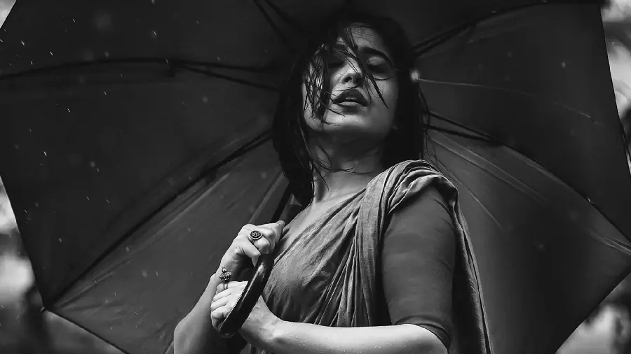 Stylish black and white image of a beautiful and beautiful girl with an umbrella