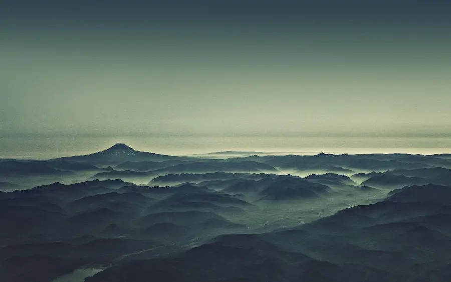 Wallpaper of another angle of a beautiful view of mountains under fog in high quality
