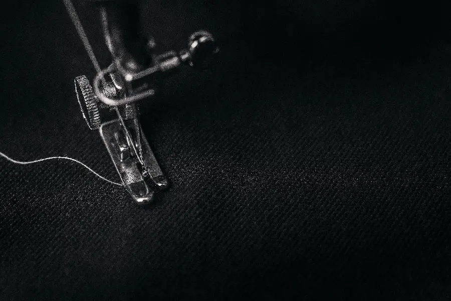 Black and white photo of sewing machine needle base 