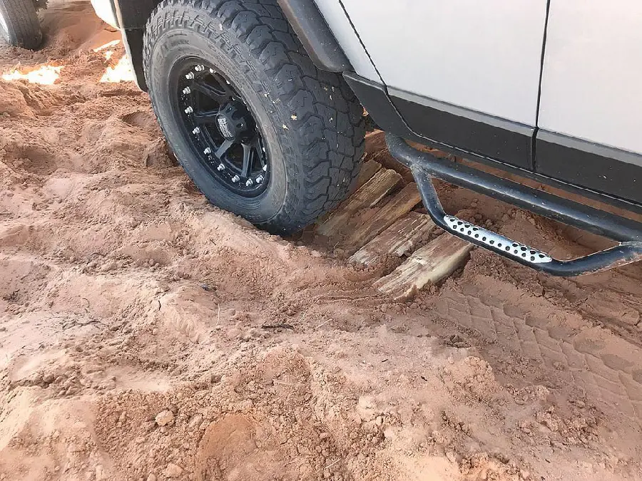 A dirty rear tire photo of an off-road vehicle by Jeff Sullivan