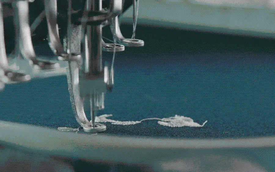 Background photo of embroidery wheel sewing on blue fabric 