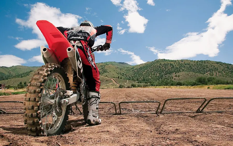 Wallpaper of a professional motocross rider behind the starting line or grid