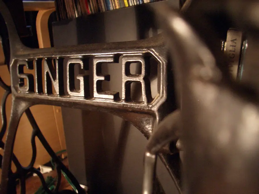 Photo of a metal Singer logo for sewing machines