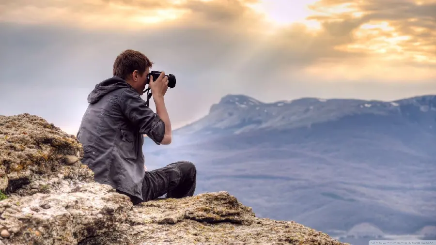 Download a beautiful image of a handsome boy taking pictures 
