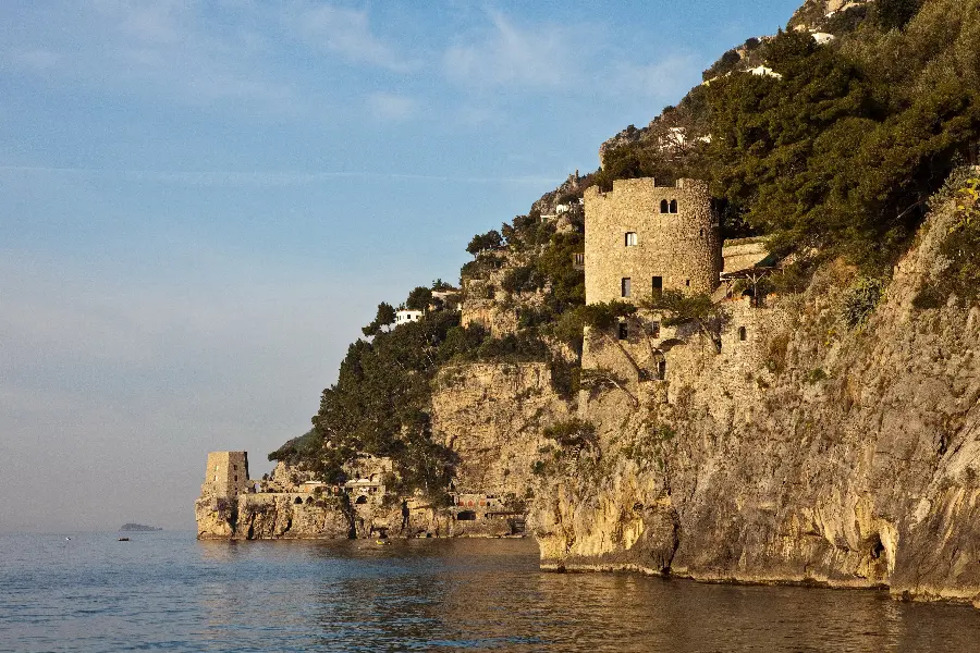 Download the photo of a lake with a high and rocky cliff in a remote and tropical island in Africa 