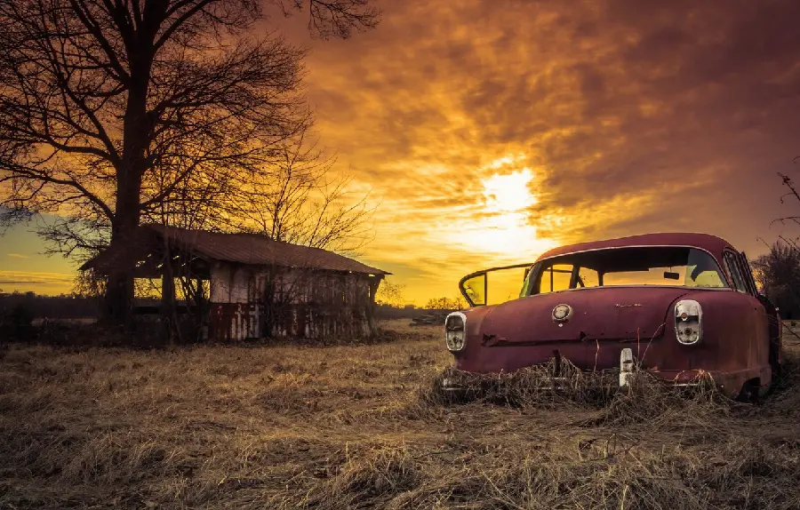 Wallpaper of an old car abandoned in an abandoned area
