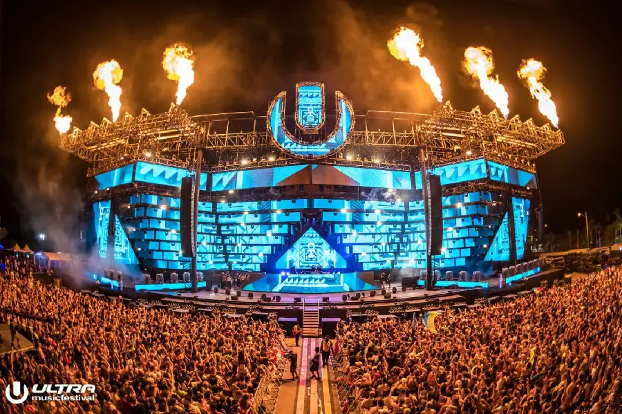 Photo of a music festival abroad with a stage designed with blue lights 