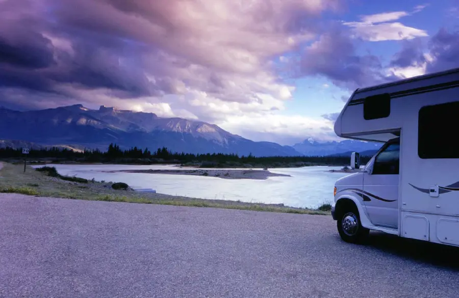 Download image of a dreamy lakeside camp with a van 