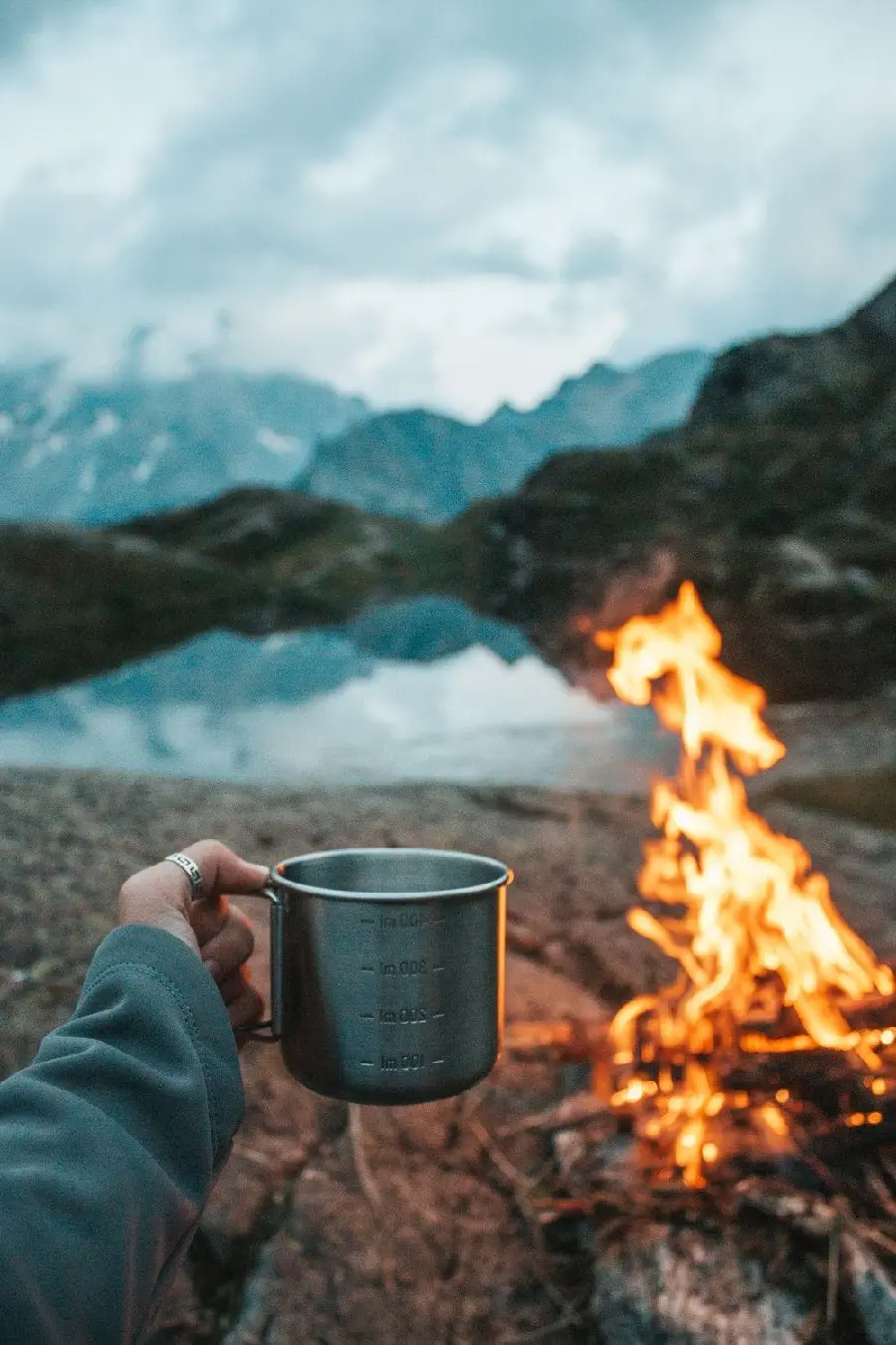 Background photo of camping by the lake with fire and hot tea 