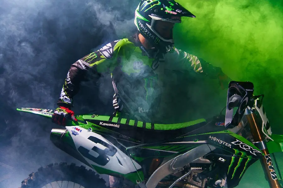 Fantastic profile photo of a Kawasaki motocross boy under green smoke
