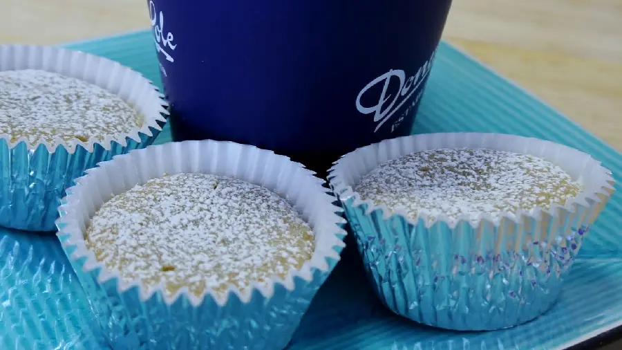 Background and photo of cupcakes decorated with powdered sugar 