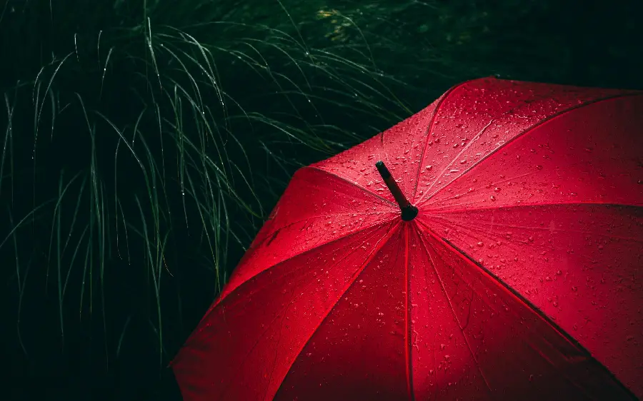 Simple image of a red raincoat umbrella suitable for writing text