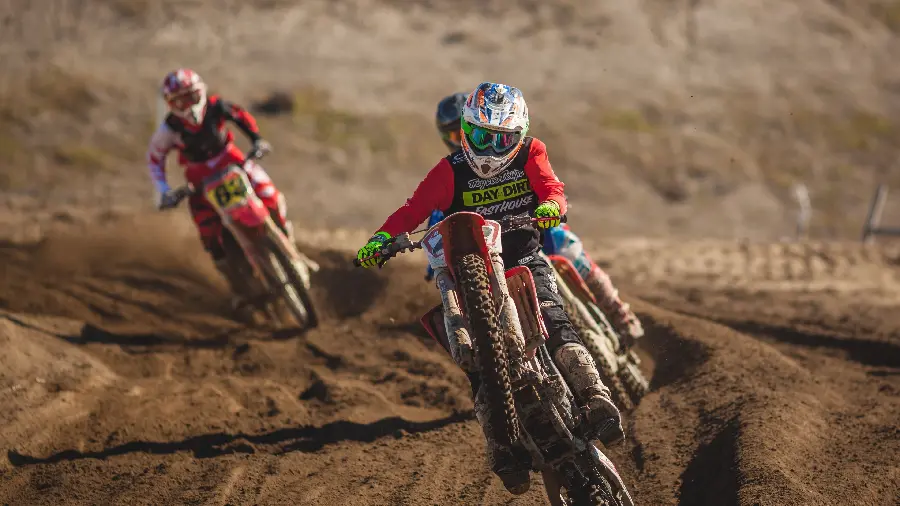 Wallpaper of two motocross riders competing on a dirt road in HD quality