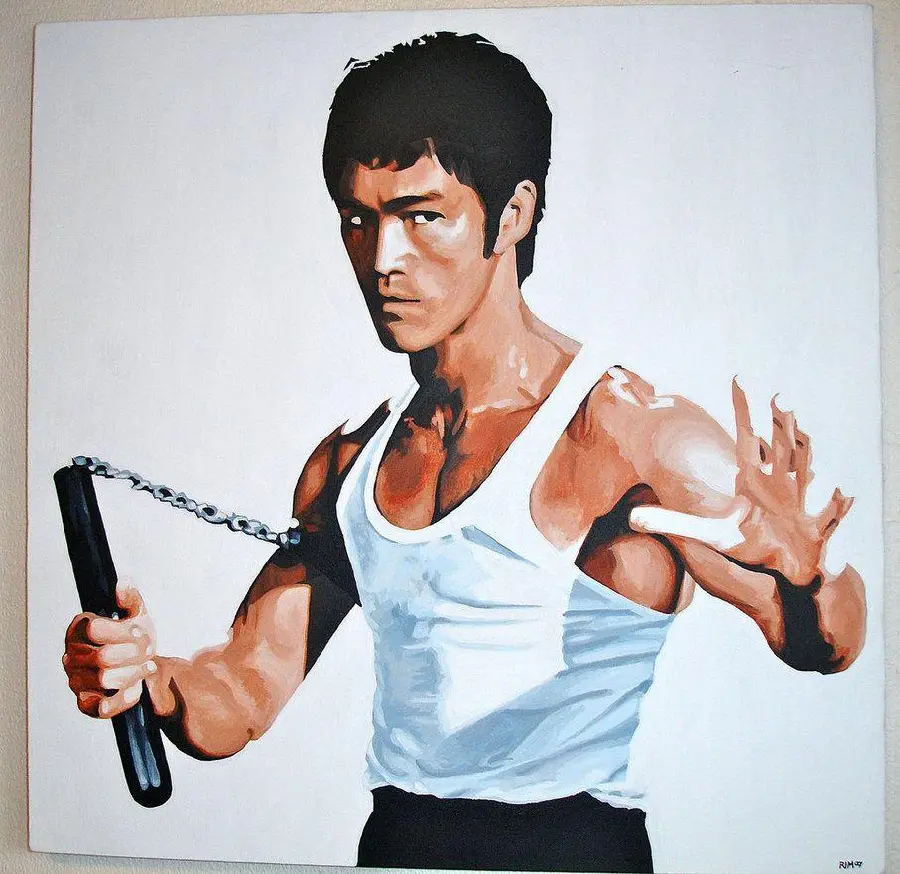Photo of Bruce Lee with Nunchucks on a white background 