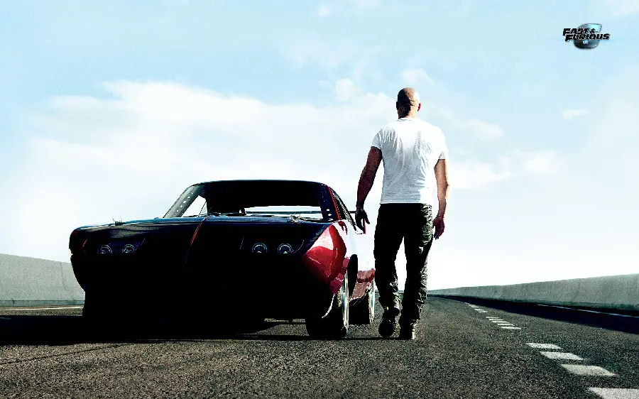 Image of the actor next to his car on the road in the Fast and Furious movie
