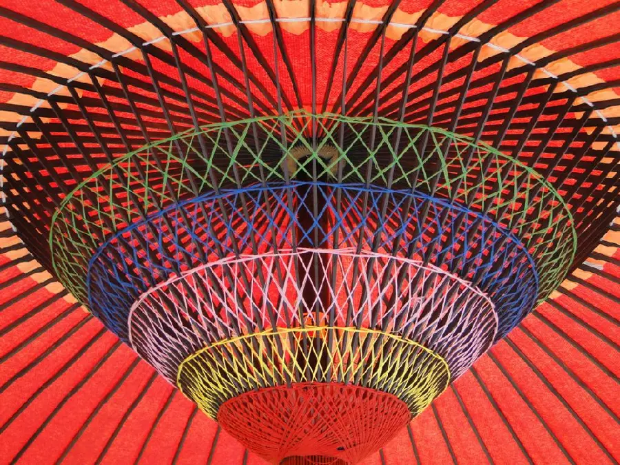 Wallpaper of a skeleton under Japanese umbrellas with a cheerful color scheme