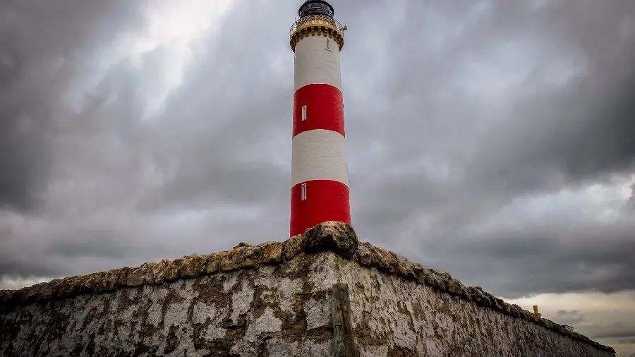 Stylish and special HD wallpaper of a dreamy lighthouse on an island beach on a stormy night