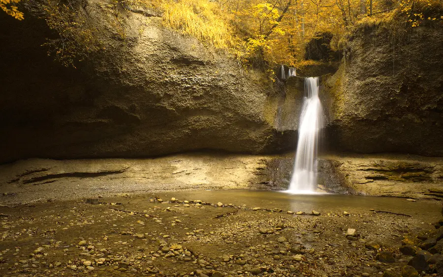 Amazing autumn landscape with a waterfall that gives a special and romantic feeling to humans 
