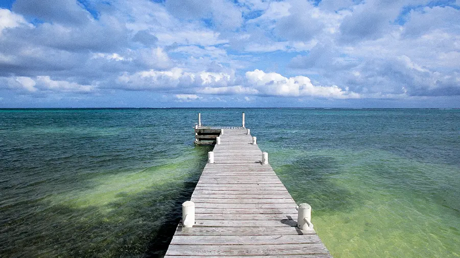 Cool artistic background from Old wooden pier with white cloud sky