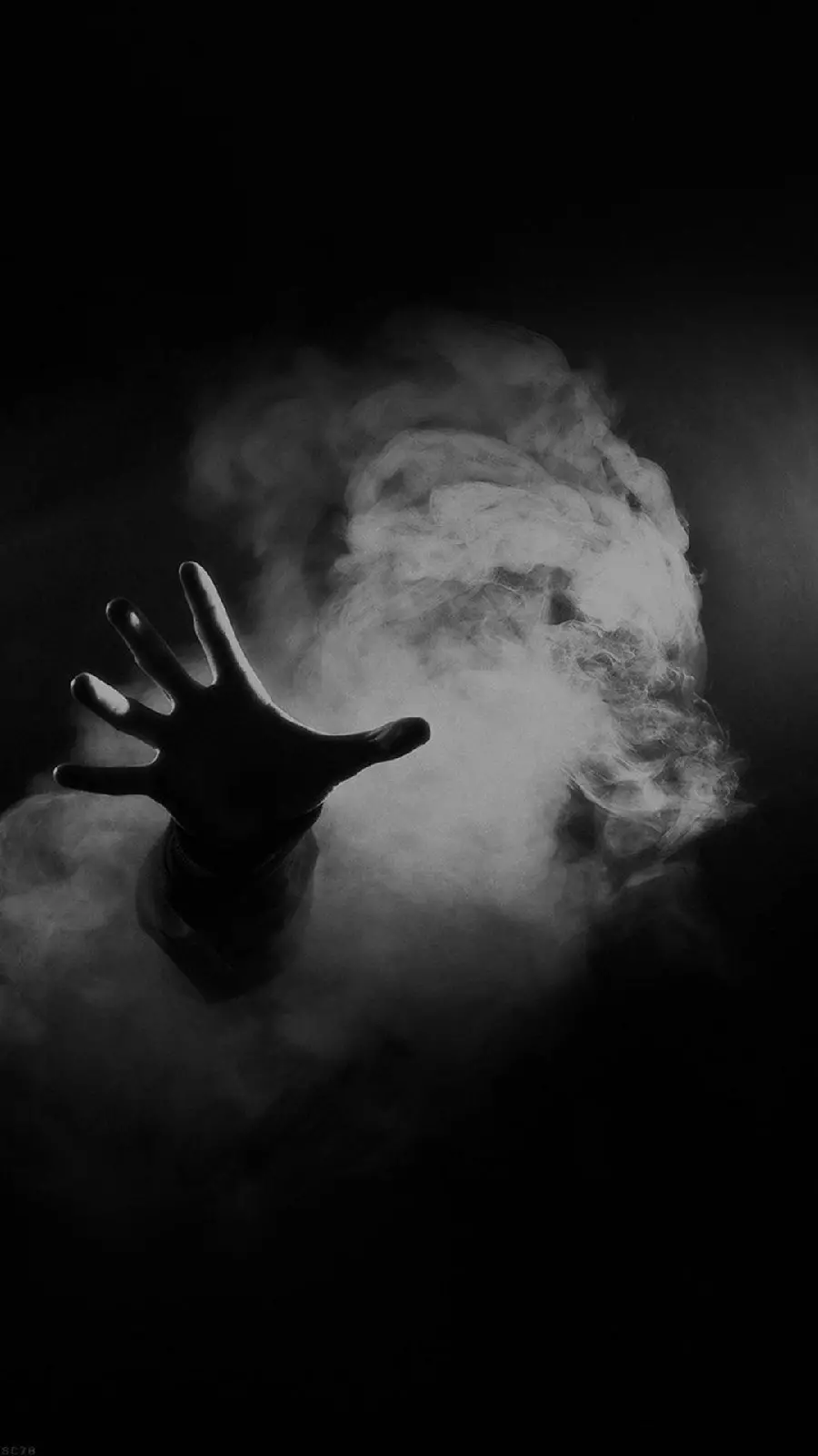 Hand photo in the darkness of black surrealism