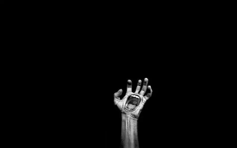 Digital and terrifying photo of a mouth in the hand of black surrealism