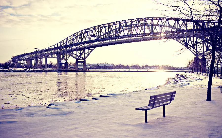 Dreamy winter wallpaper of bridge and bench on snow 