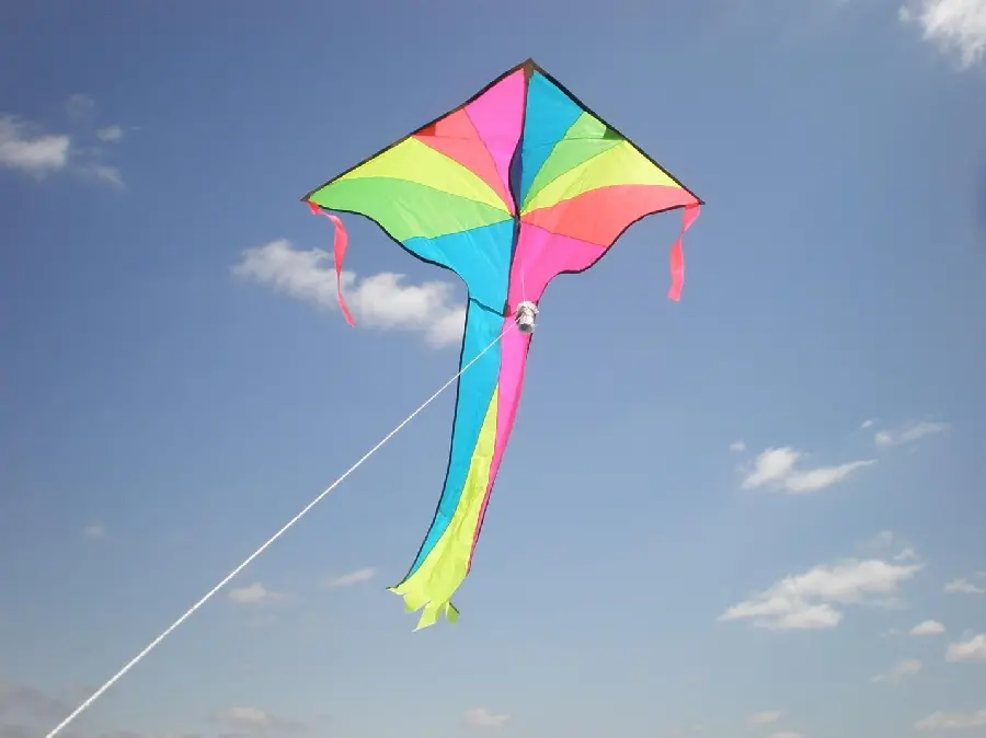 Wallpaper of a colorful kite flying in the sky