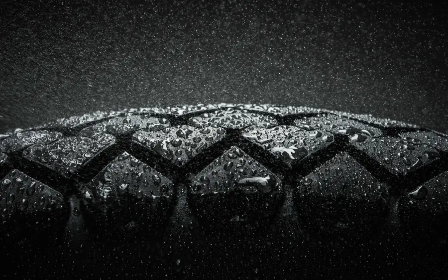 A close-up macro portrait of dew drops on a tire