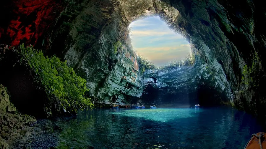 Beautiful dark cave mouth wallpaper in the heart of the earth with a blue background 